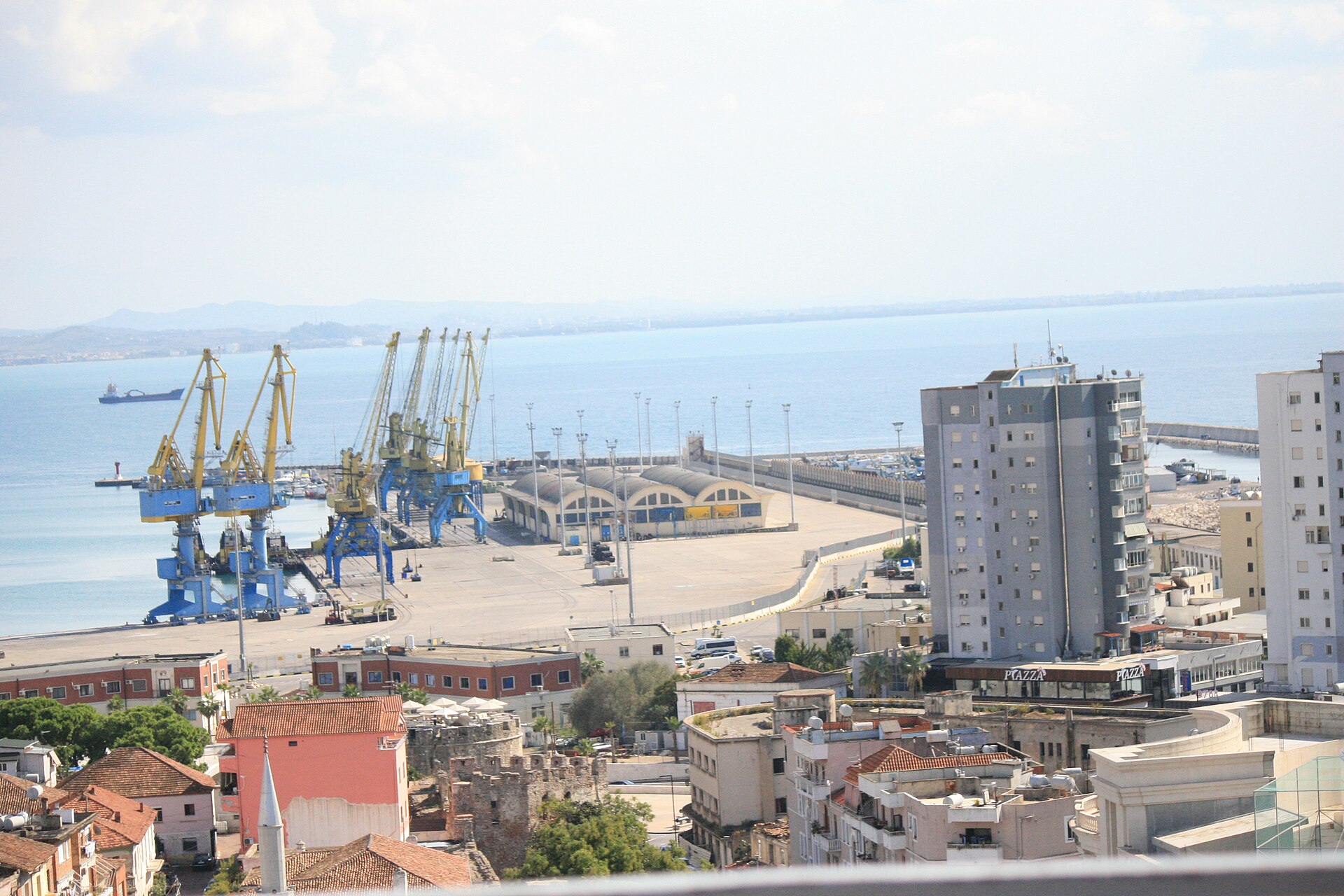 Port cranes and waterfront buildings in Durrës beside the Adriatic Sea